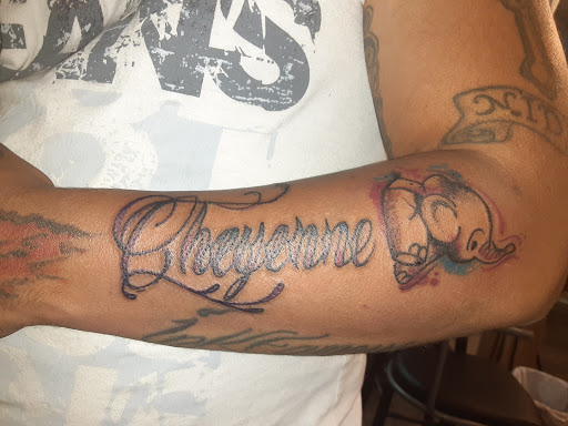 Explore lower back cover up tattoo ideas, creative tattoo ideas in Camden, available at Twisted Tattoo And Piercings