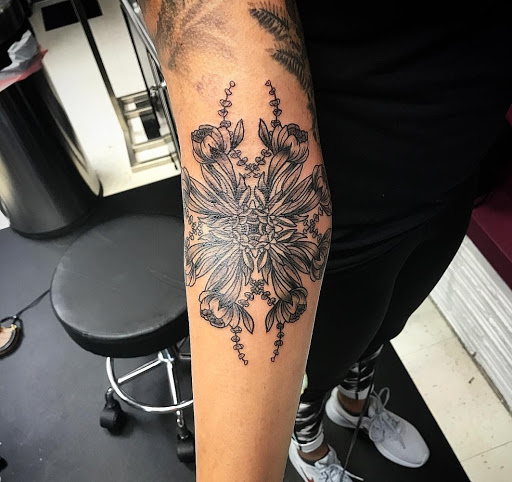 Find tattoo ideas between breast for your next unique tattoo in Milwaukee at Bay Street Tattoo Co.