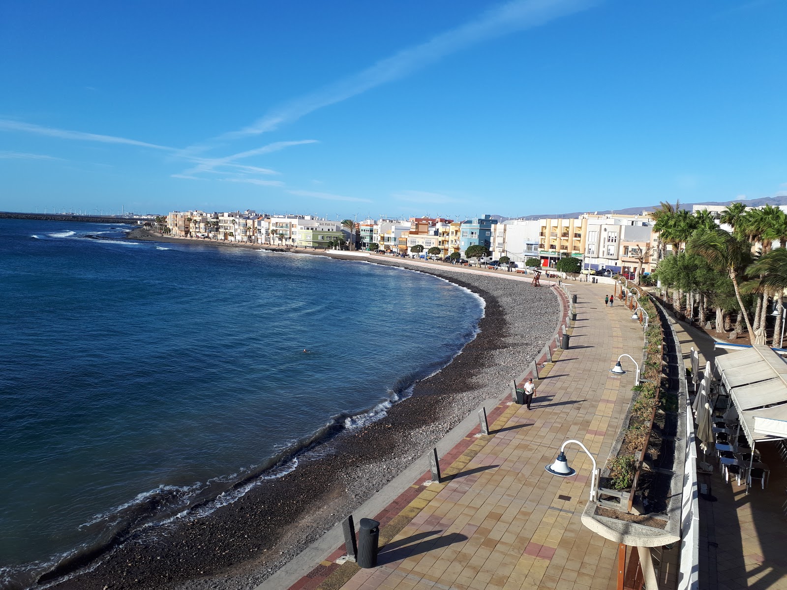 Foto von Arinaga Strand mit schwarzer sand & kiesel Oberfläche