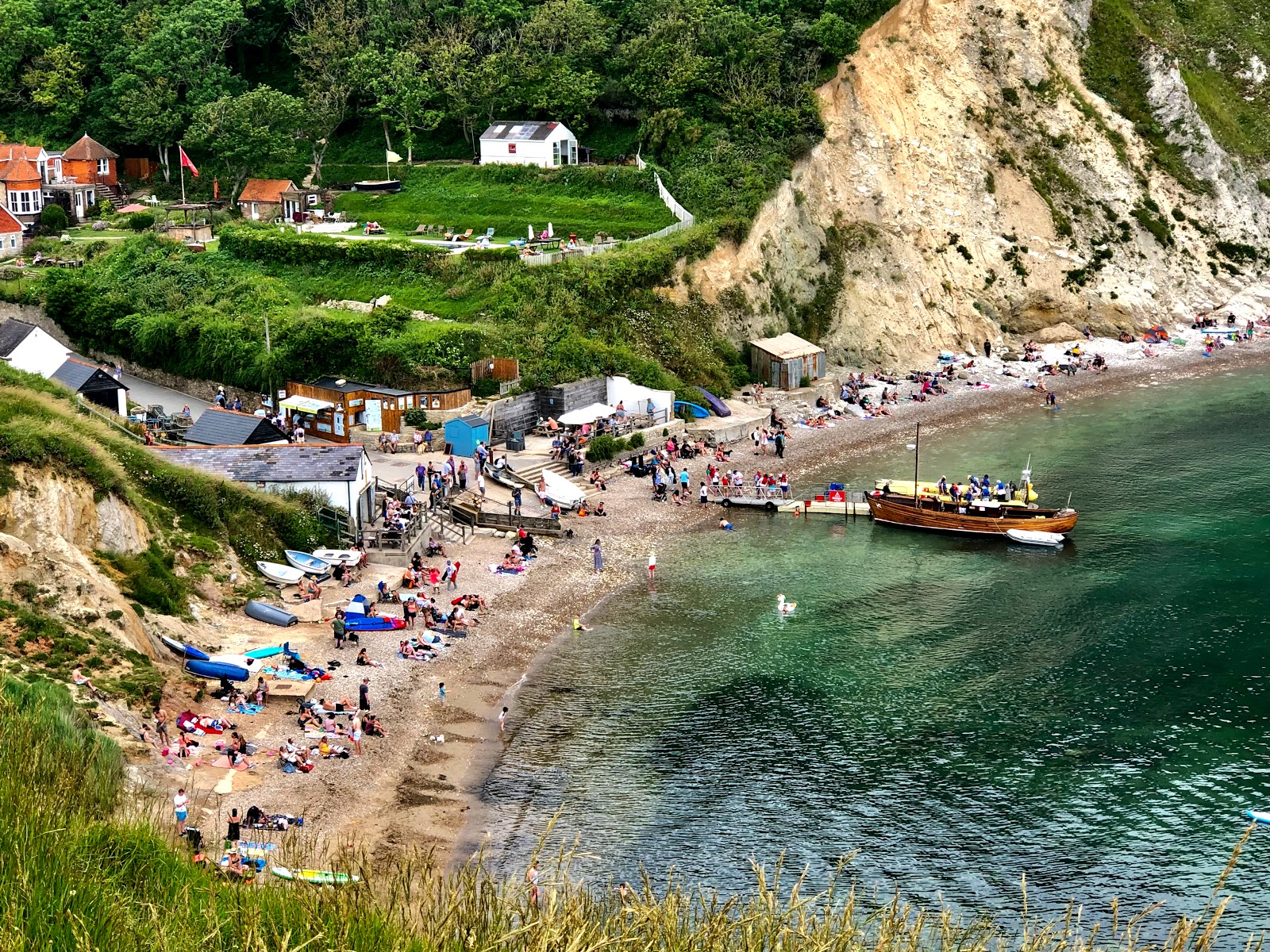 Photo of Lulworth Cove with rocks cover surface