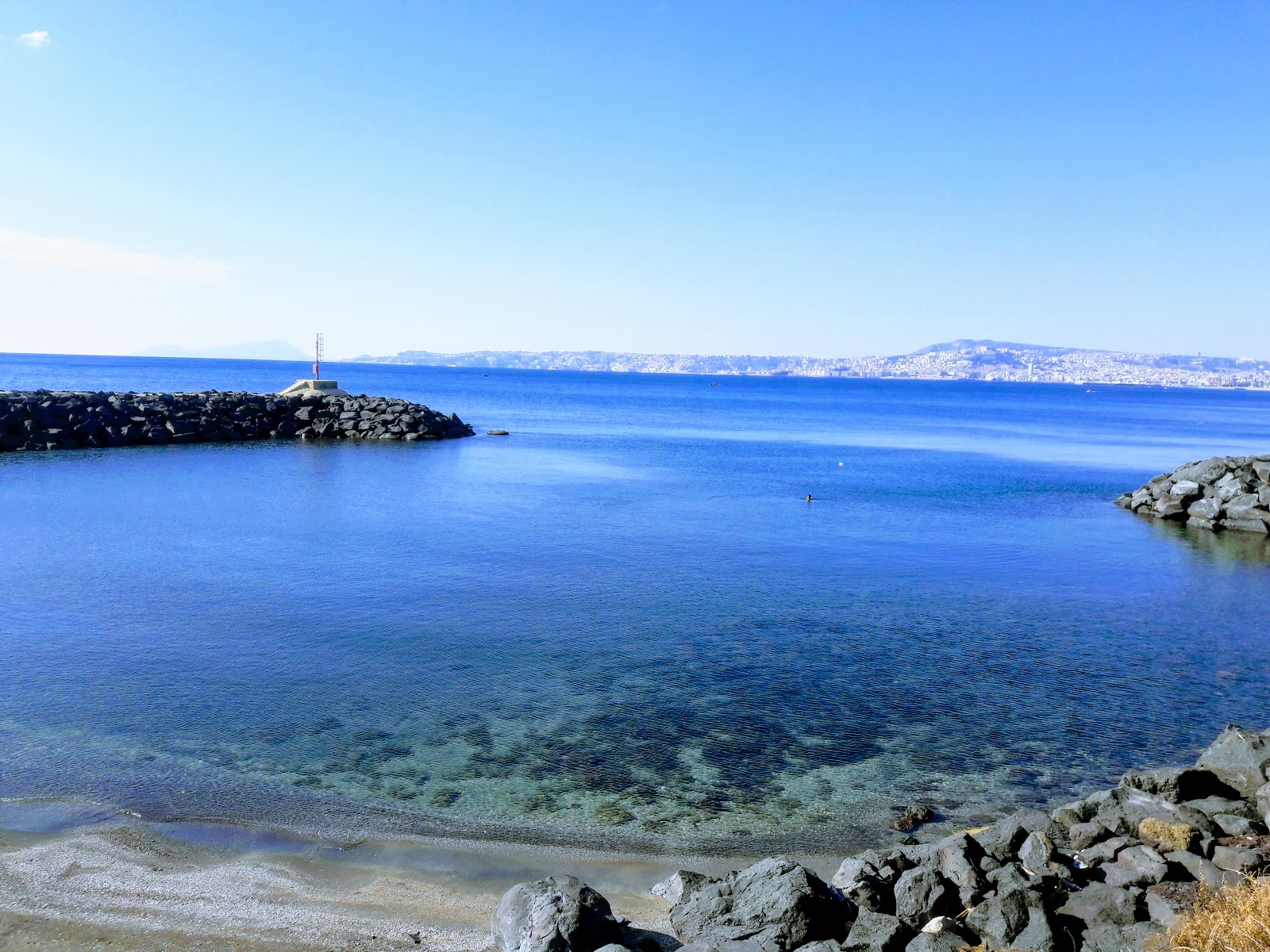 Spiaggia del Granatello的照片 带有蓝色的水表面