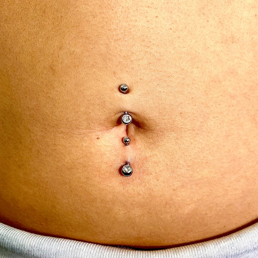 Explore sideburn tattoo ideas, creative tattoo ideas in Orange, available at Symbiosis Body Piercing