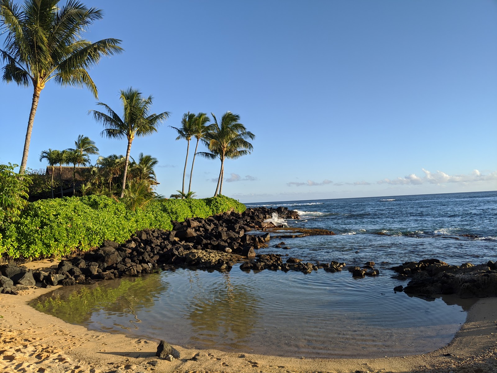 Photo of Keiki Cove Beach with bright sand & rocks surface
