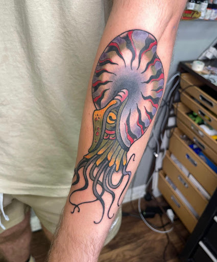 Explore tricep tattoo ideas for men, creative tattoo ideas in Baltimore, available at Rippd Canvas Tattoo Shop Artists Social Club