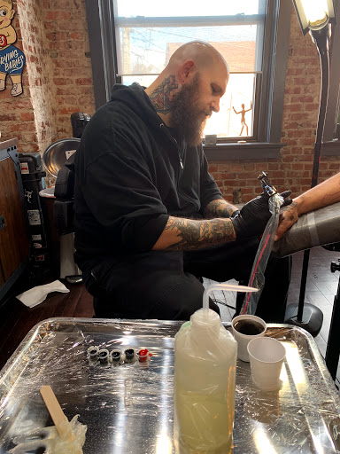 Explore little dragon tattoo ideas, creative tattoo ideas in Kansas City, available at Golden Stag Tattoo and Gallery