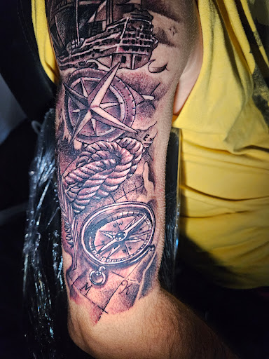 Explore tattoo ideas for women thigh, creative tattoo ideas in Angola, available at Hoodlum Ink