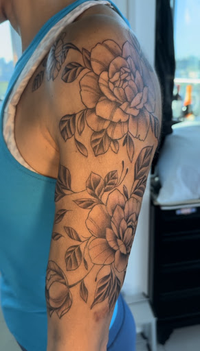 Explore black flower tattoo ideas, creative tattoo ideas in Astoria, available at Kings of Queens Tattoo Studio