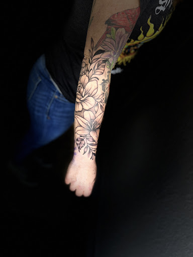 Explore dragonfly flower tattoo ideas, creative tattoo ideas in Osage Beach, available at Lake Ozark Tattoo and Hair Studio