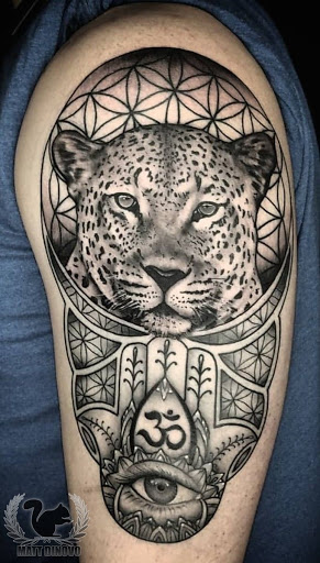 Find between breast tattoo ideas for your next unique tattoo in Council Bluffs at Black Squirrel Tattoo