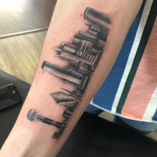 Find tattoo ideas for under the breast for your next unique tattoo in Frisco at Frisco Tattoo Company - Steel PaintBrush