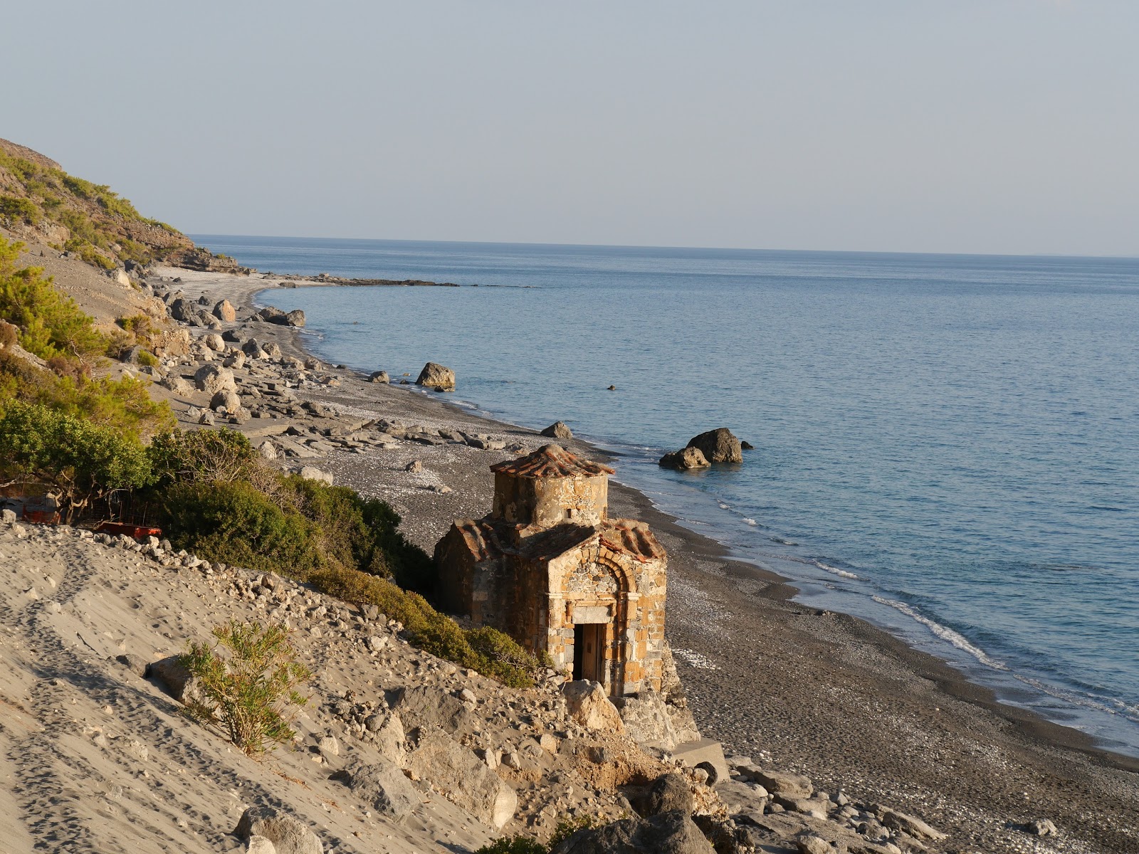 Photo of Ag. Pavlos beach backed by cliffs