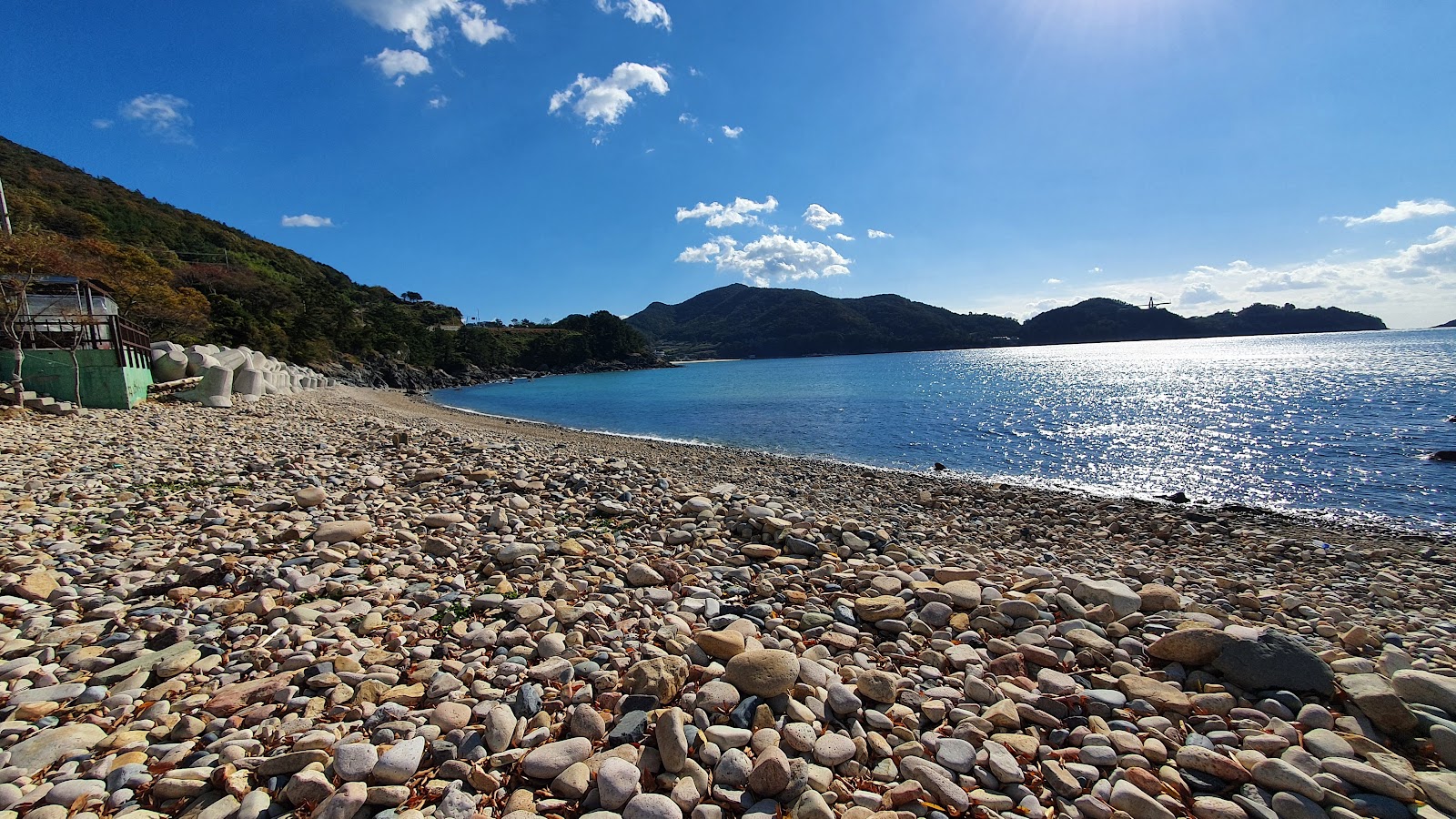 Cheonha Beach'in fotoğrafı geniş bir kıyı şeridi ile birlikte