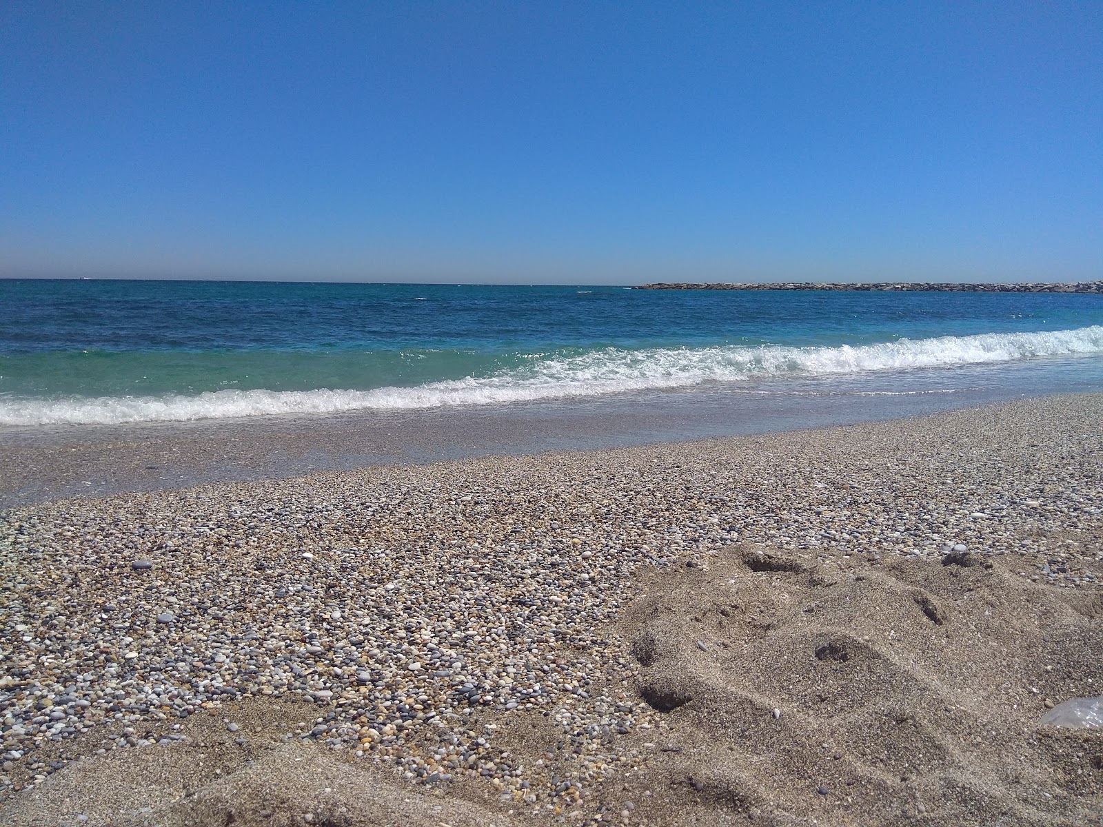 Foto di Playa Torrevigia con una superficie del acqua cristallina