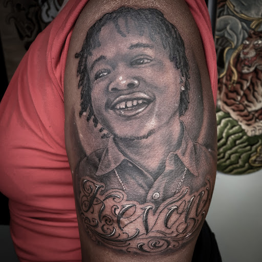 Explore hood neck tattoos ideas, creative tattoo ideas in Greenville, available at Great Wolf Tattoo