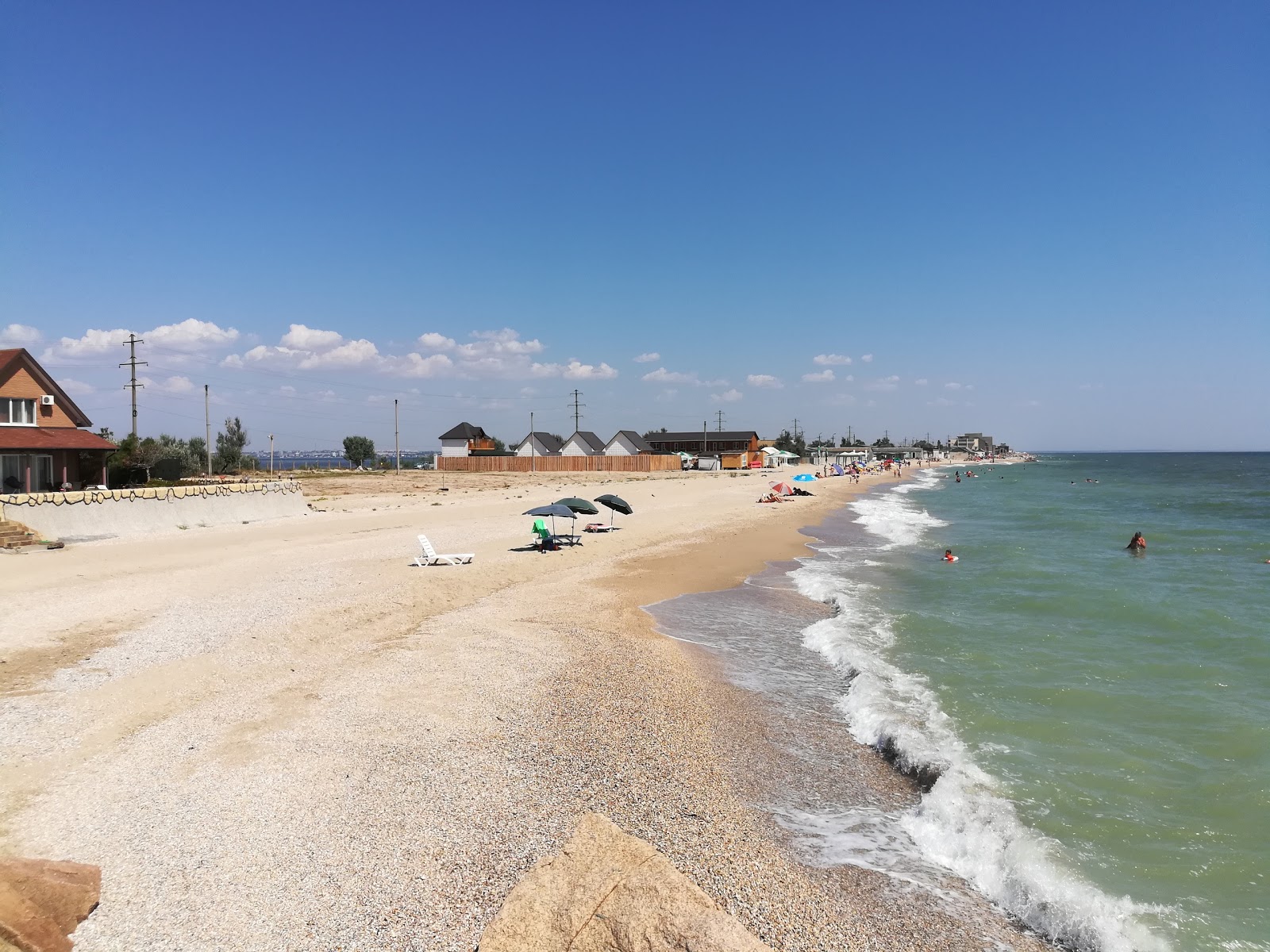Fotografija Solomennyy Plyazh z svetel pesek površino
