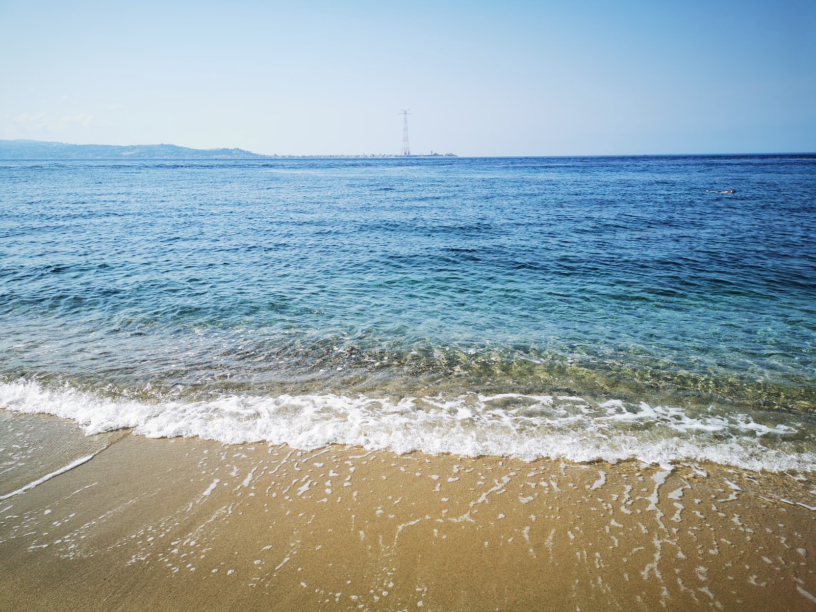 Foto di Porticello beach con una superficie del acqua blu