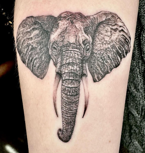 Explore wrap around tattoo ideas, creative tattoo ideas in Broxton, available at Seratonin Tattoo Parlor