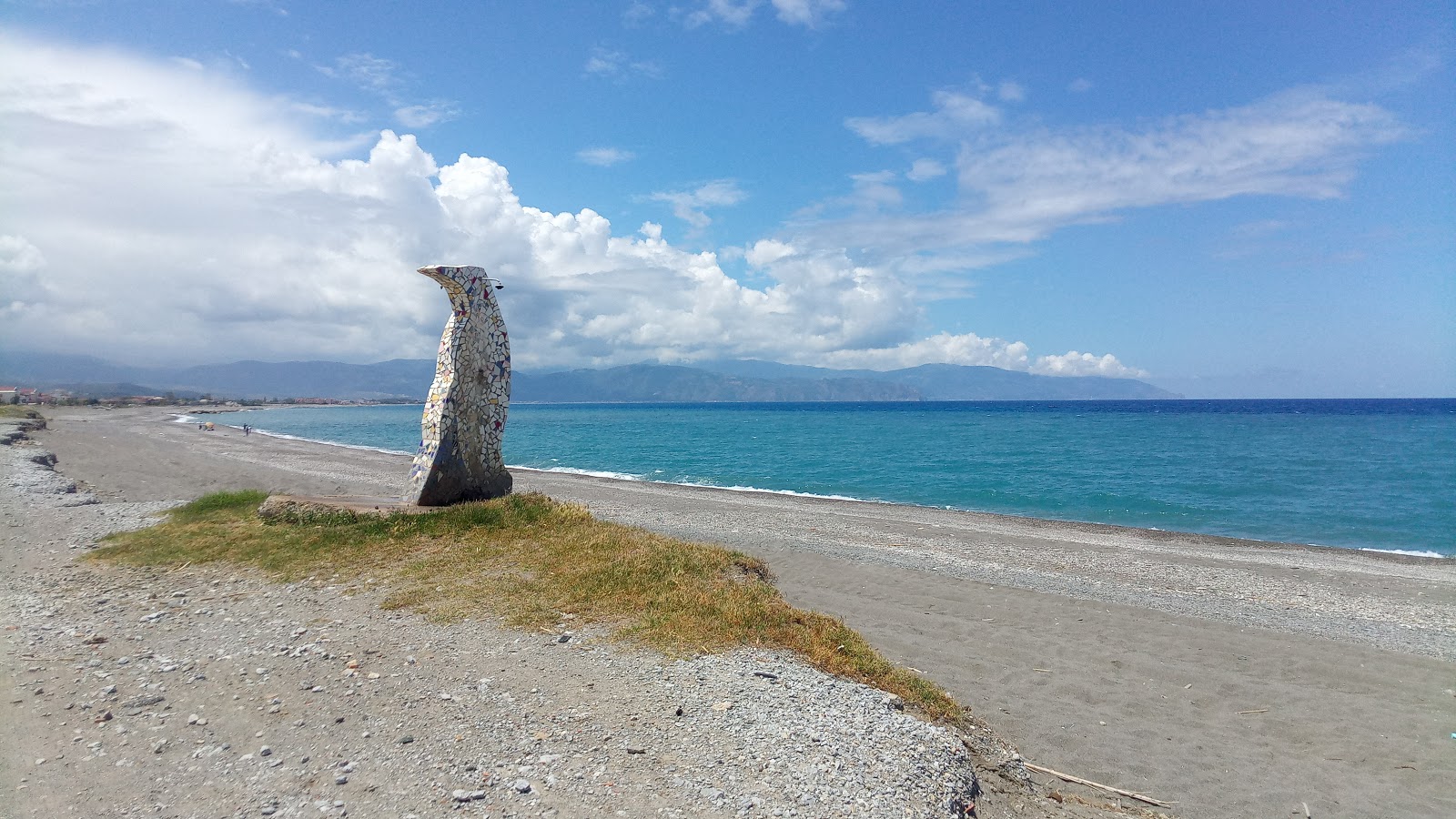 Foto di Spiaggia di Spinesante con una superficie del sabbia grigia e ciottoli
