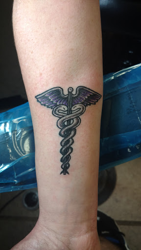 Explore red hand tattoo ideas, creative tattoo ideas in Denison, available at Mad House Tattoos