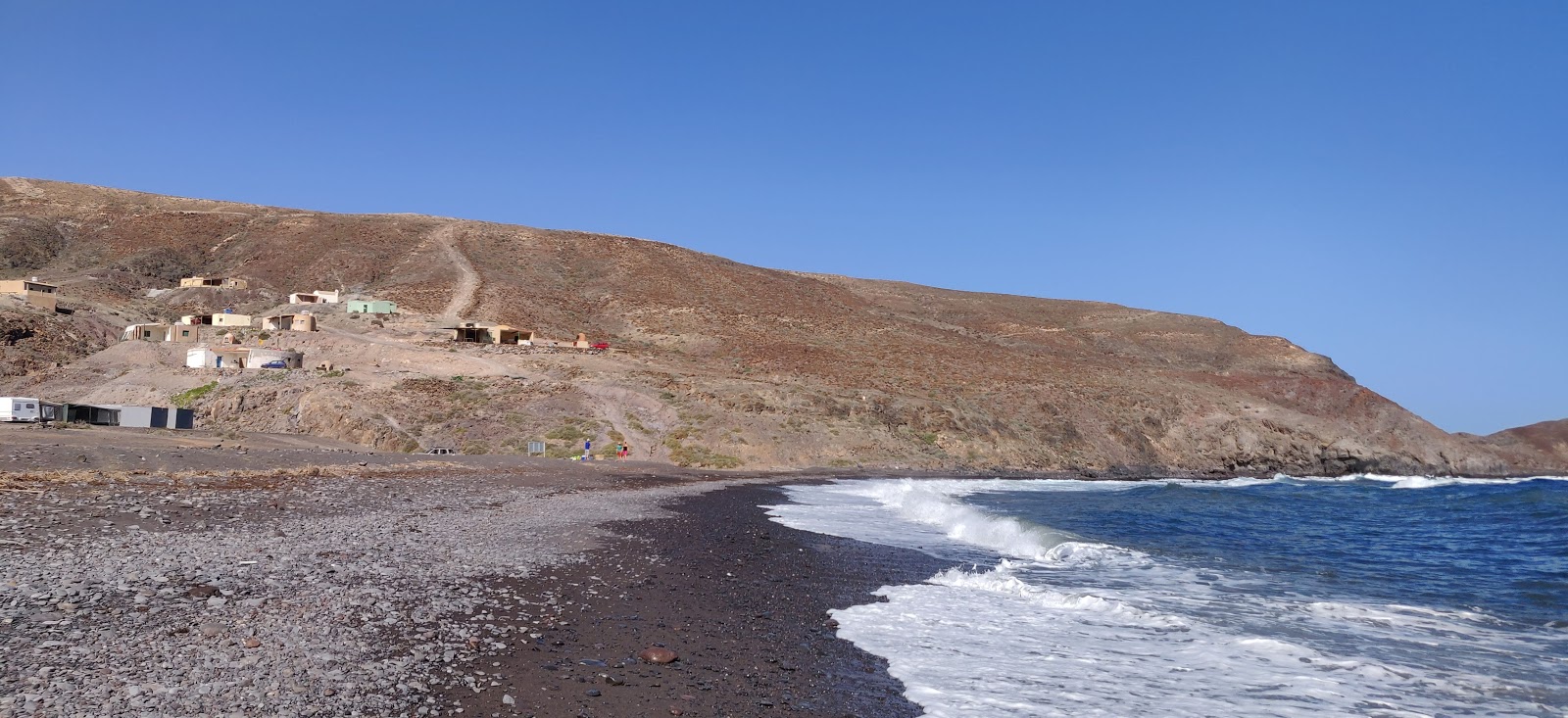 Foto av Playa de Gran Valle med harmaa hiekka ja kivi yta