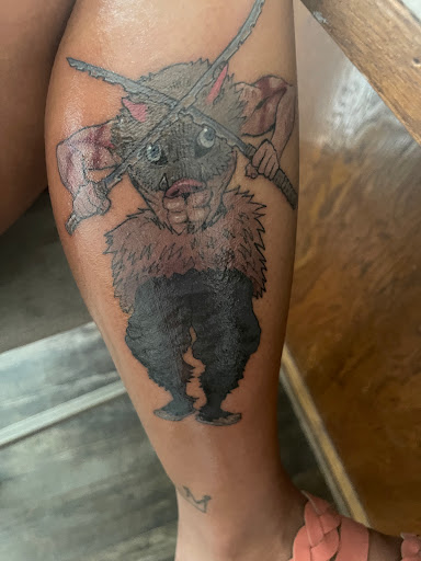 Explore bicep tattoo ideas for men, creative tattoo ideas in Orange, available at The Original Goodfellas Tattoo and Piercing