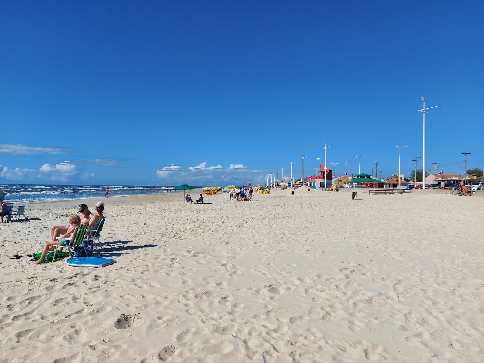 Foto di Praia de Imbe con una superficie del sabbia beige fine