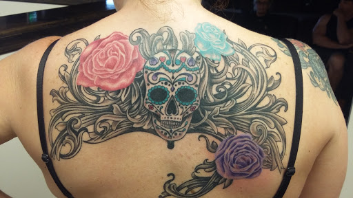 Explore red cardinal tattoo ideas, creative tattoo ideas in Louisville, available at Cryptic Ink Tattoo Studio