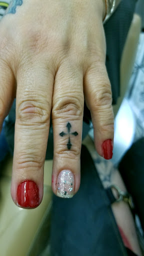 Explore cross with names tattoo ideas, creative tattoo ideas in Santa Fe, available at Rivers Collective Body Art