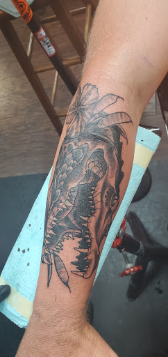 Explore reading tattoo ideas, creative tattoo ideas in Jacksonville, available at Fat Kat Tattoo & Body Piercing