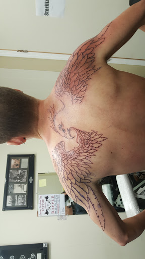 Explore lower half sleeve tattoo ideas for females, creative tattoo ideas in Hays, available at Fantasy Graphics Tattoo Studios