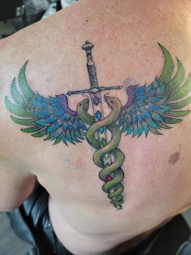 Explore gun tattoo ideas, creative tattoo ideas in Tacoma, available at Garfield Street Tattoo Co