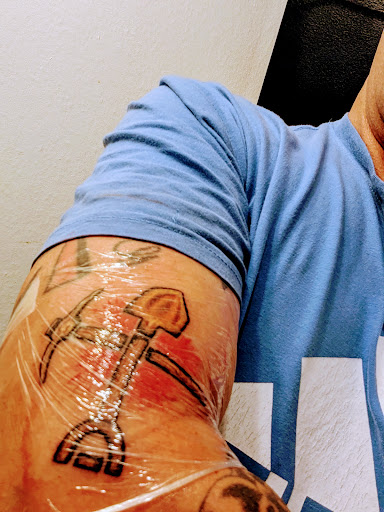 Explore cover up tattoo ideas for guys, creative tattoo ideas in Redding, available at The Salty Sloth Tattoo