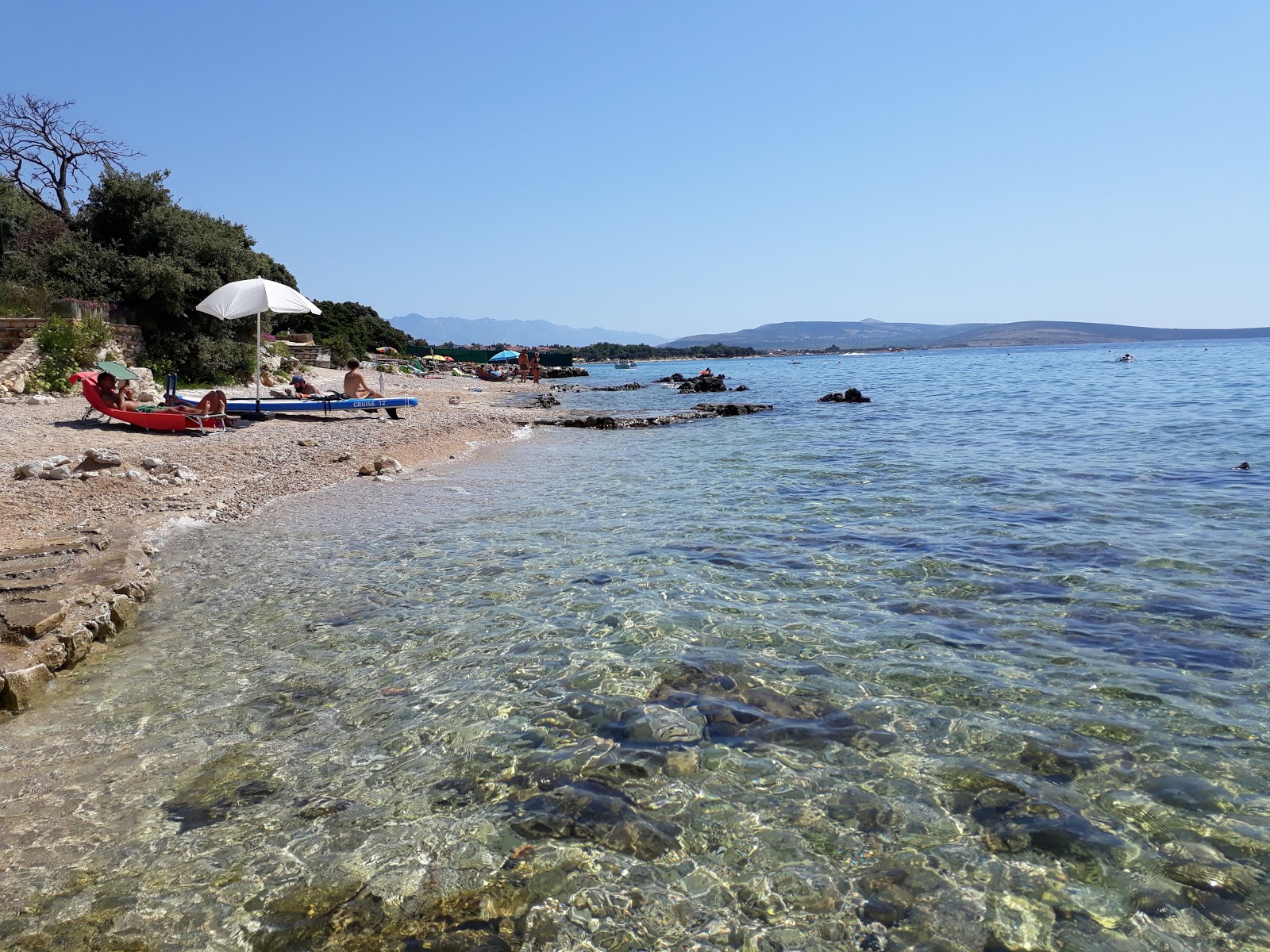 Foto av Scare beach med turkos rent vatten yta