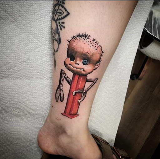 Explore fist tattoo ideas, creative tattoo ideas in Cedar Falls, available at The Iron Quill Tattoo Parlor