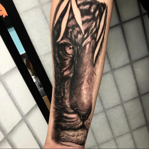 Find charm bracelet tattoo ideas for your next unique tattoo in Johnson City at Gold Cross Tattoo Co.