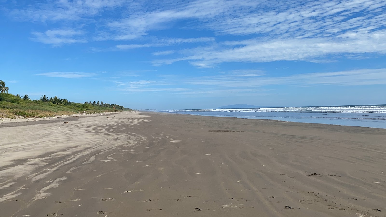 Foto av Icacal beach med grå sand yta