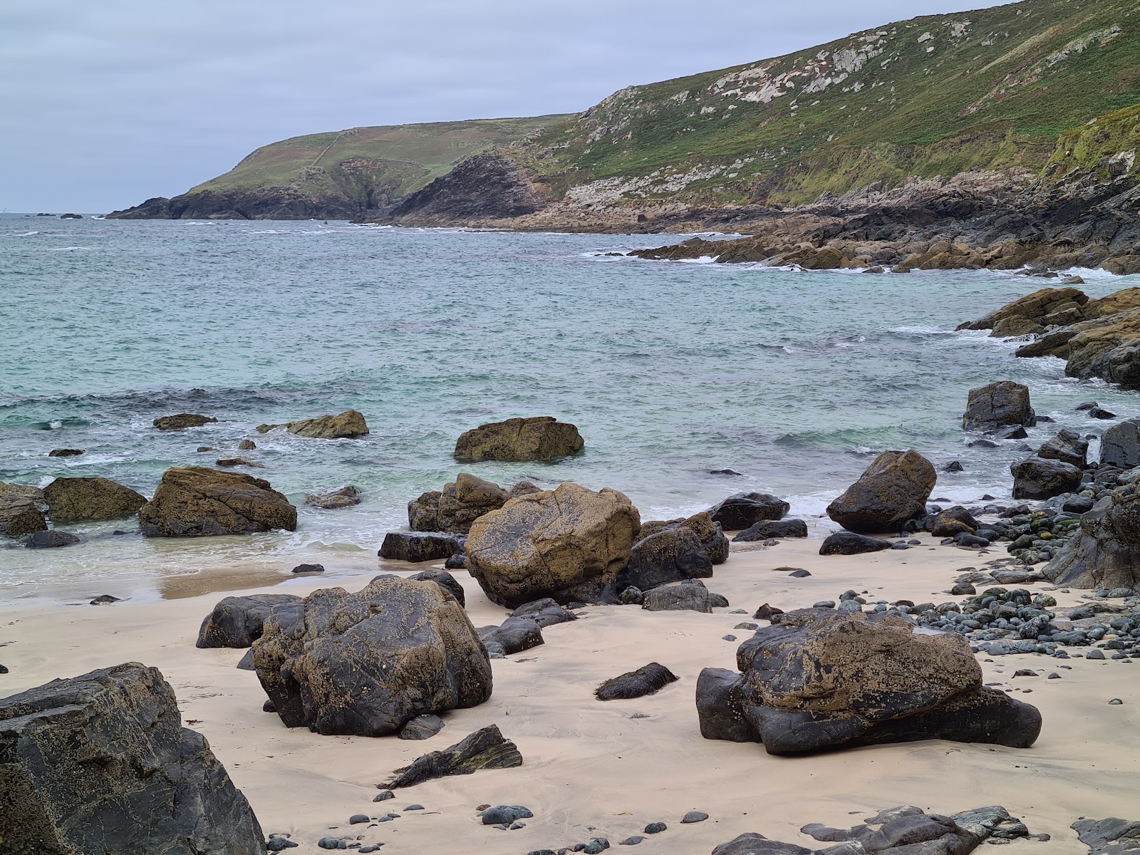 Photo of Porthzennor Cove with rocks cover surface