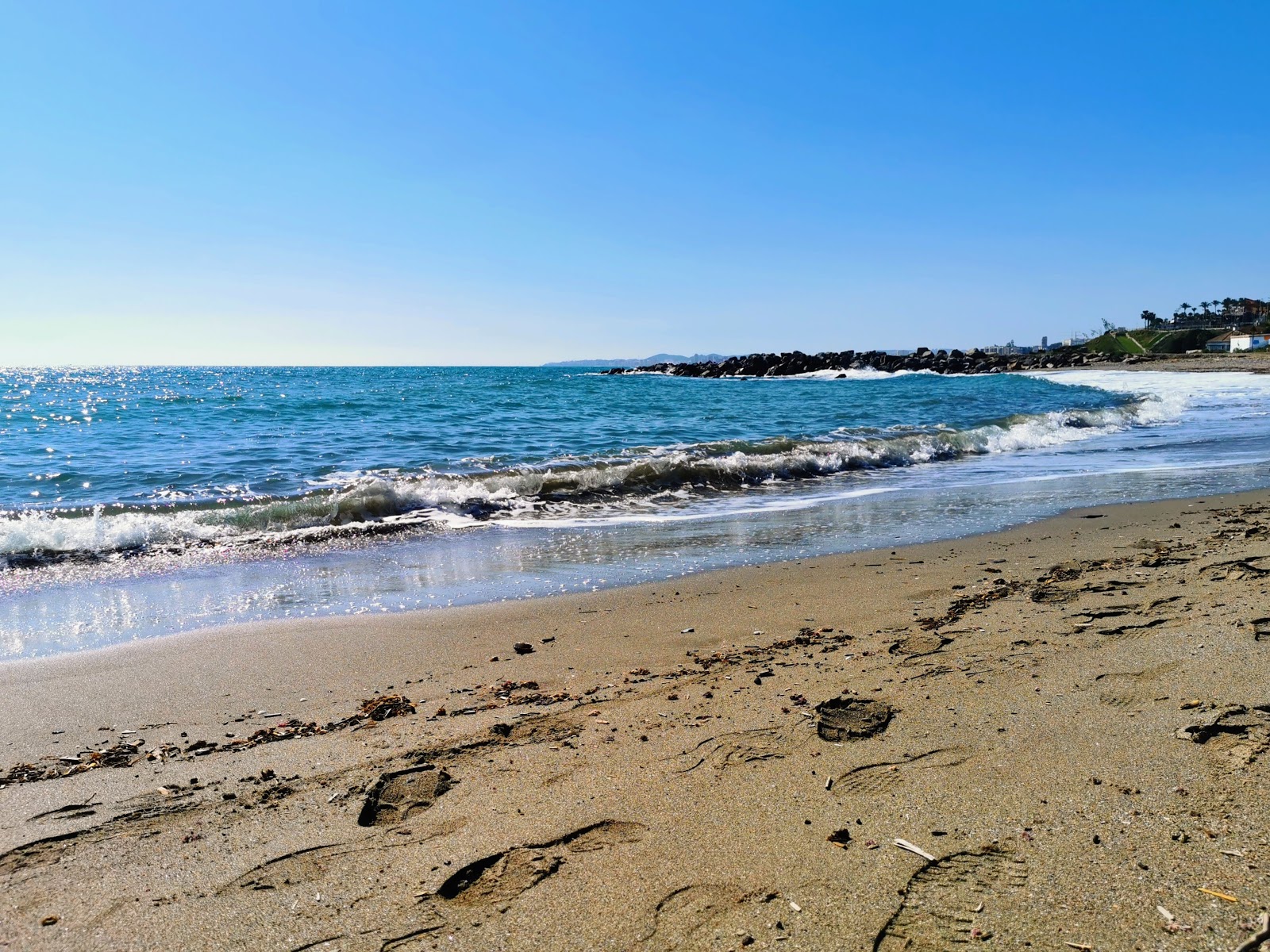 Foto de Playa la Perla com pequena baía