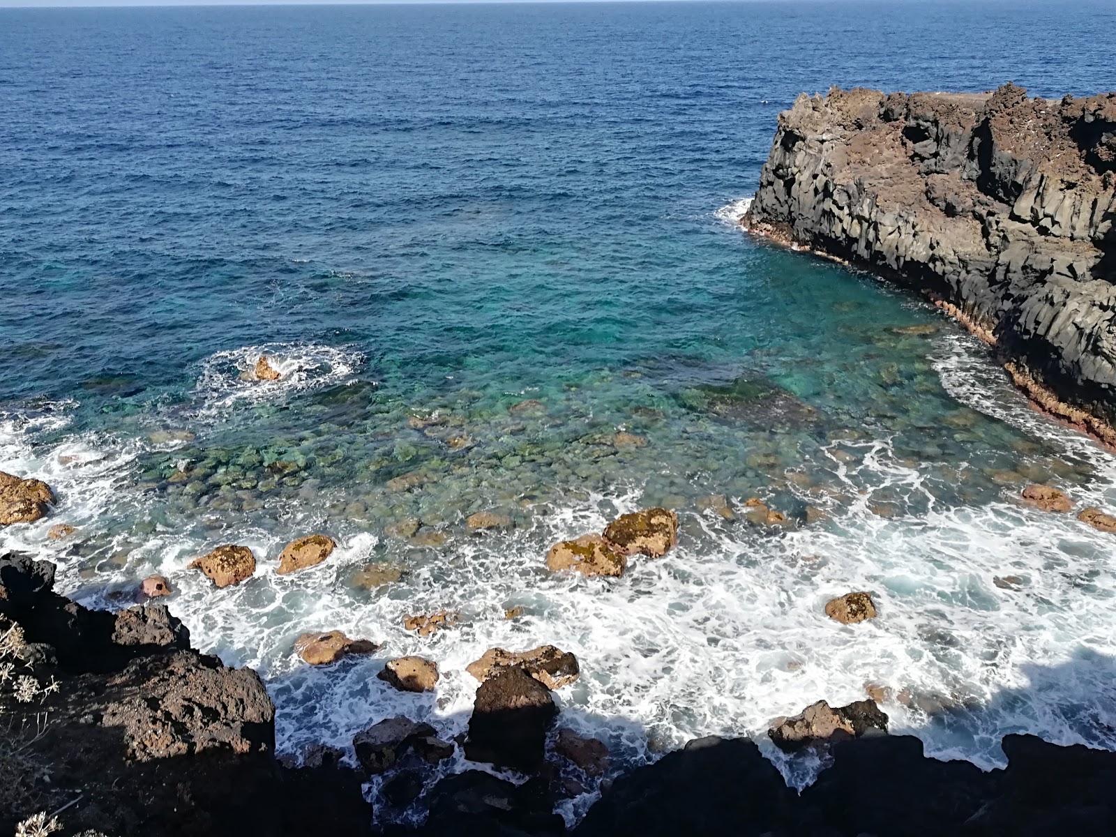 Photo of Playa de los Palos with blue pure water surface
