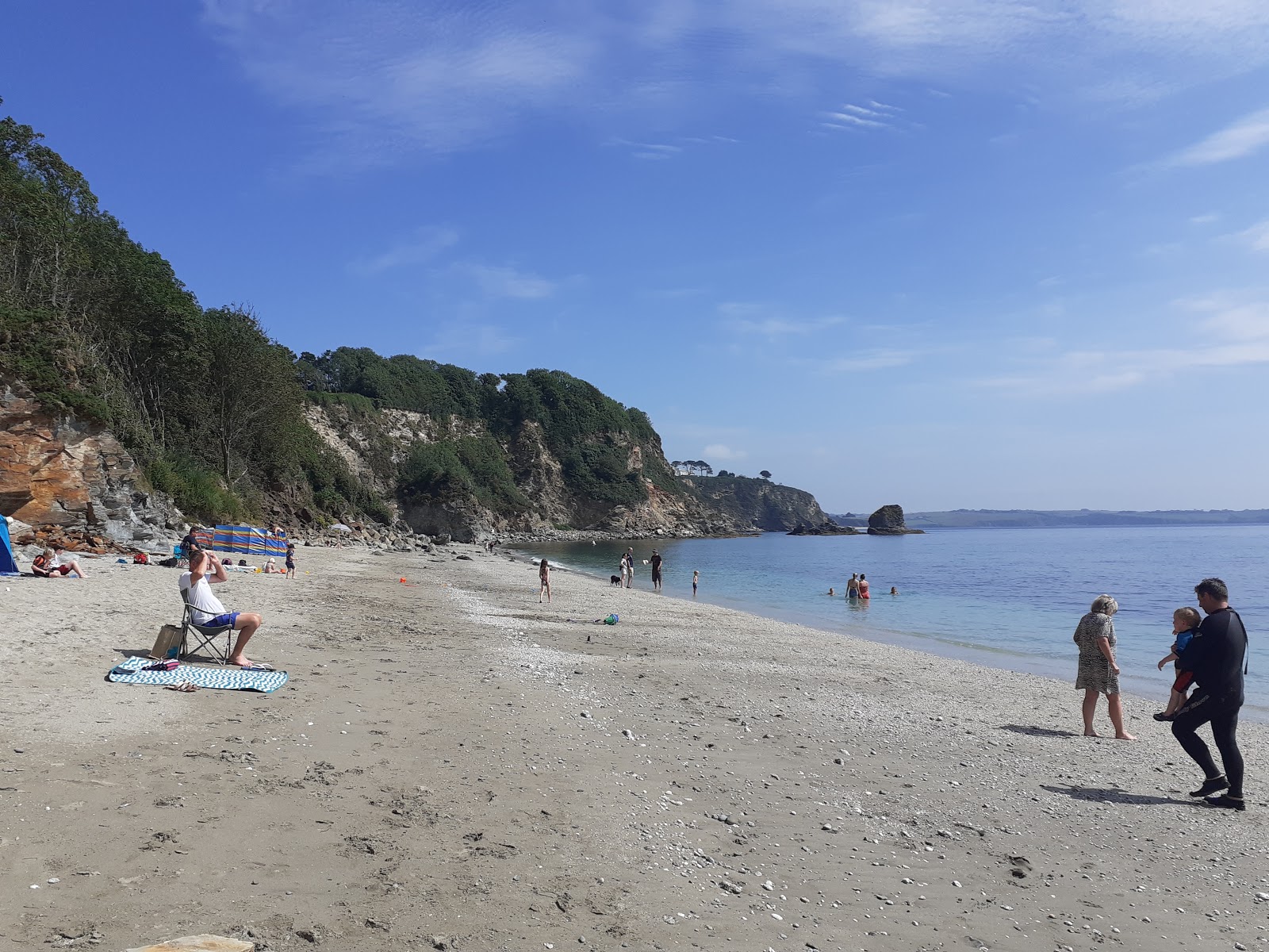 Photo of Duporth beach with turquoise pure water surface