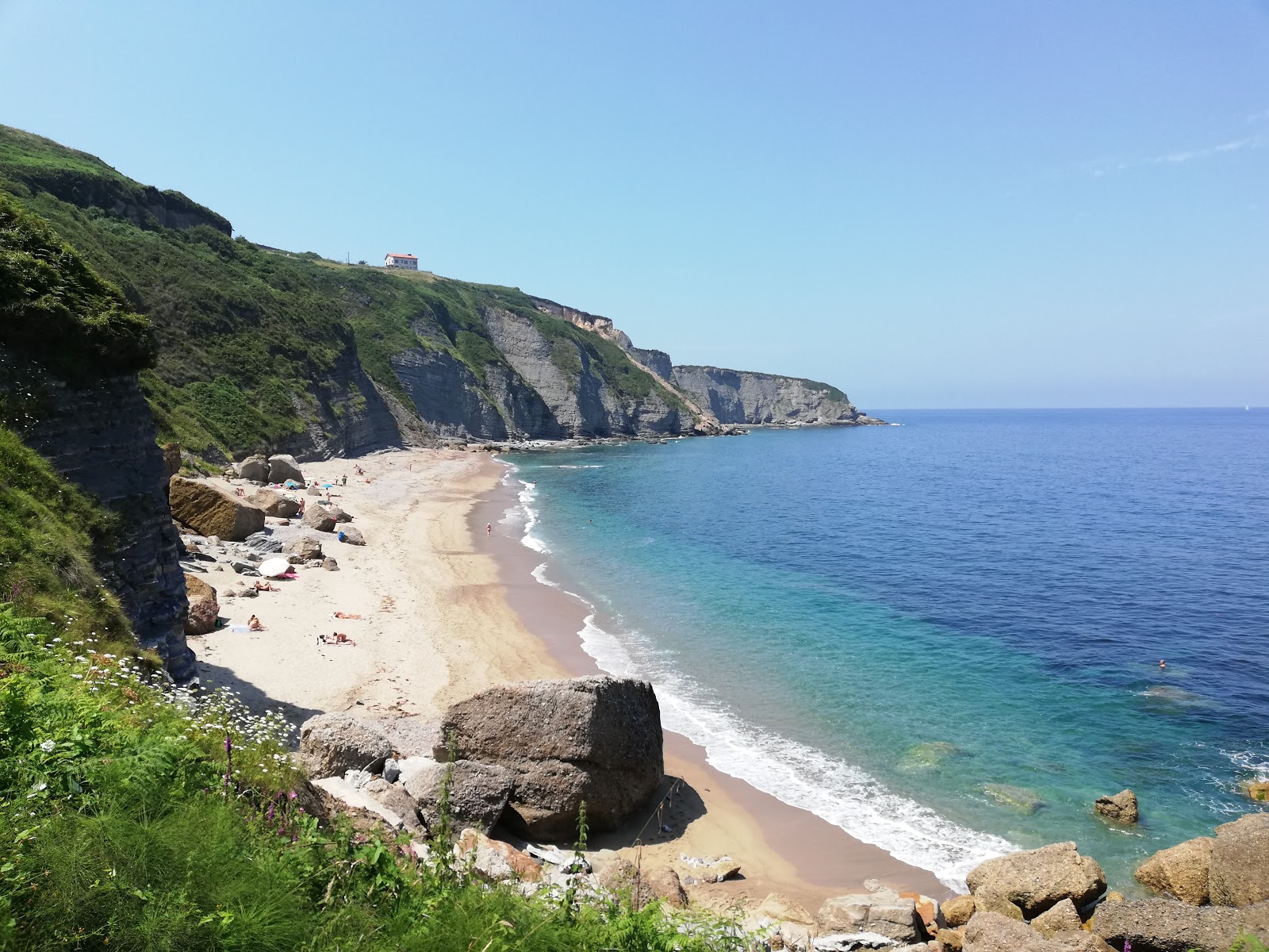 Foto av Playa de Serin med turkosa vatten yta