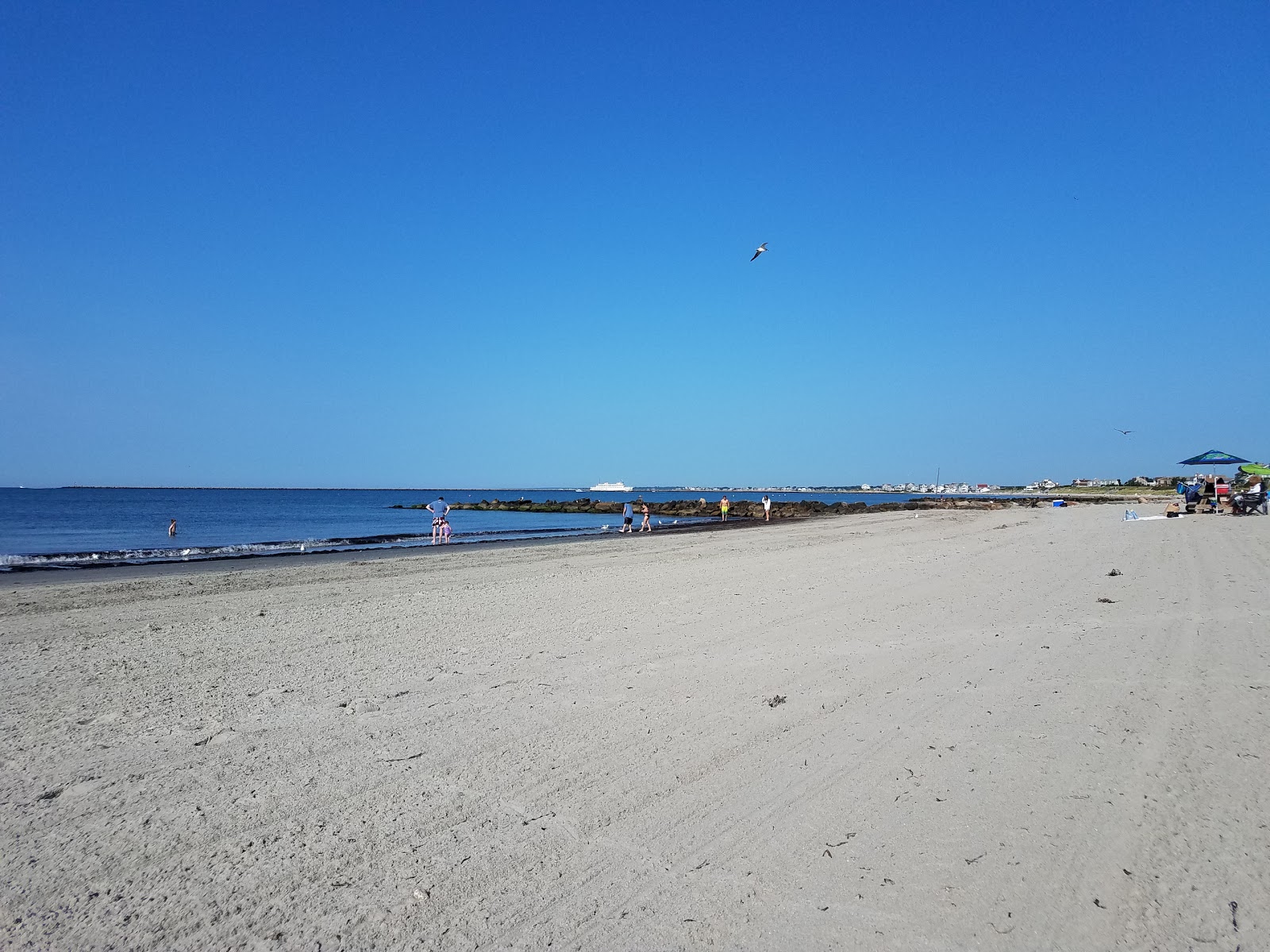 Photo of Roger Wheeler Beach with turquoise water surface