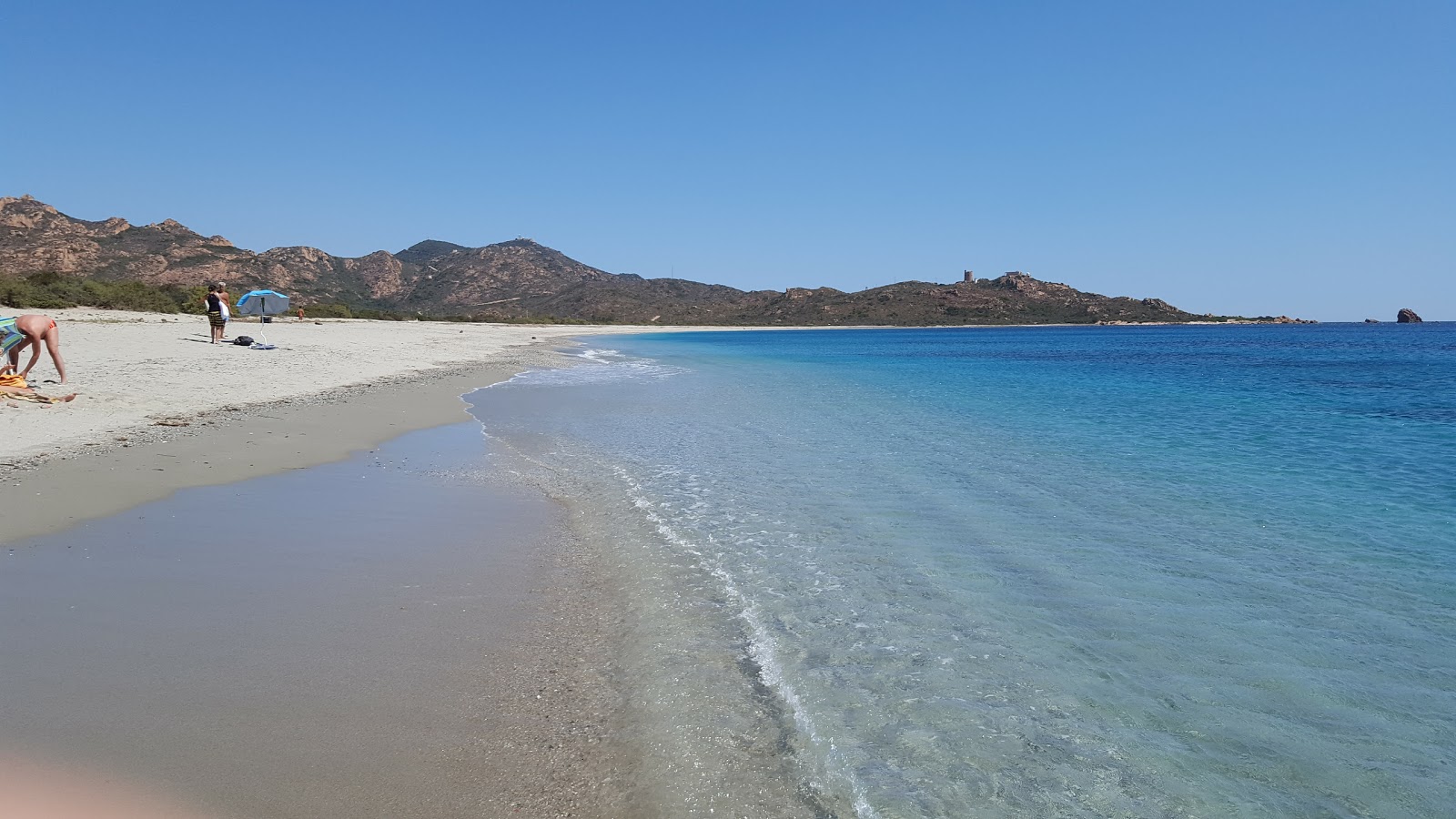 Foto van Porto Corallo met helder fijn zand oppervlakte