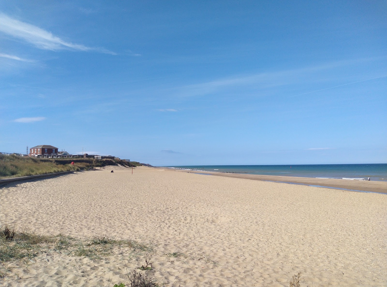 Photo of Bacton Beach with turquoise pure water surface