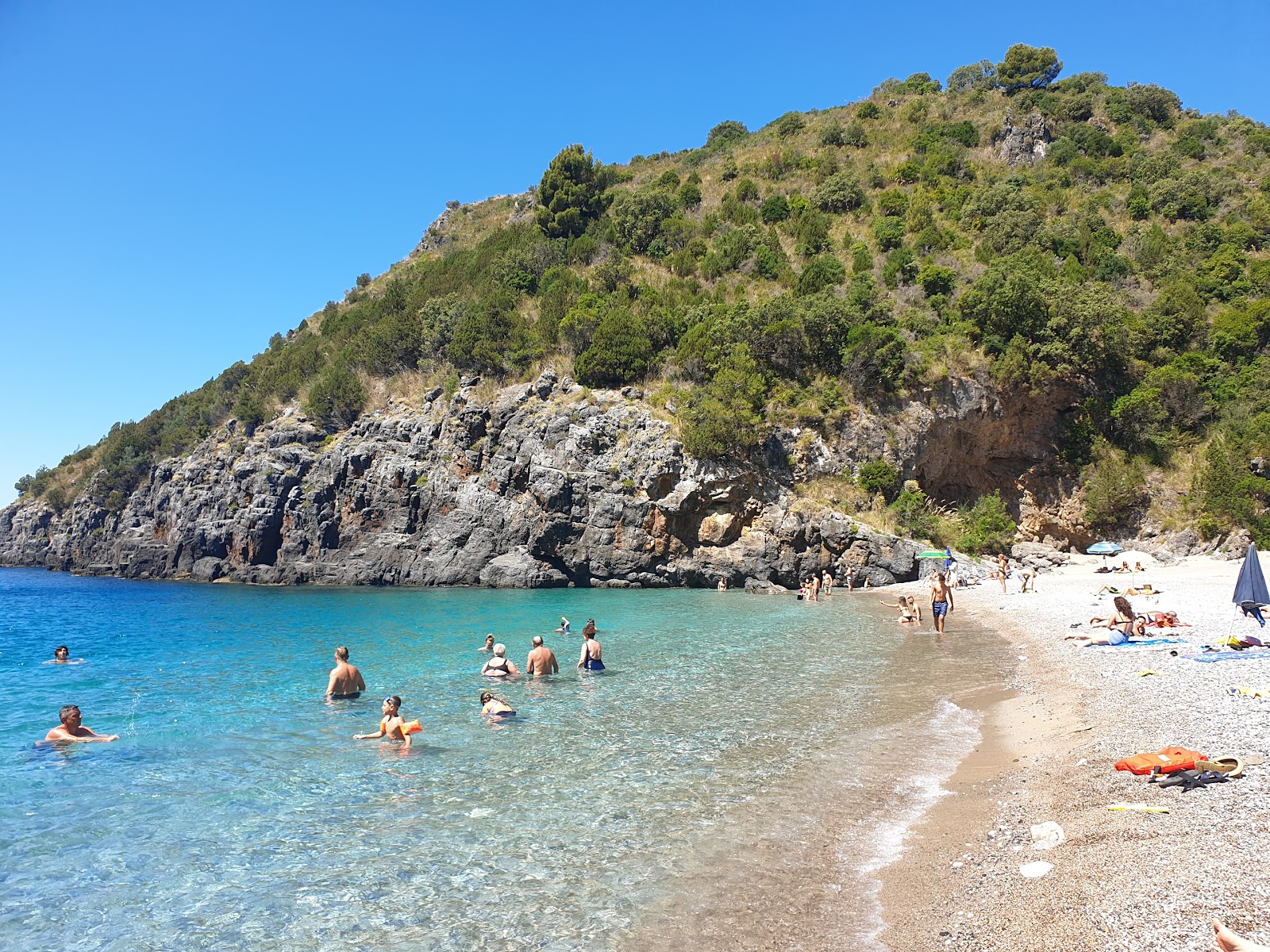 Photo of Cala Bianca with blue pure water surface