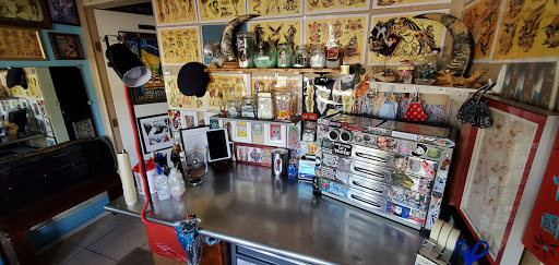 Explore tattoo ideas for weightlifters, creative tattoo ideas in Englewood, available at The Original Big Daddy Tattoo & Body Piercing est.1997 est.1997