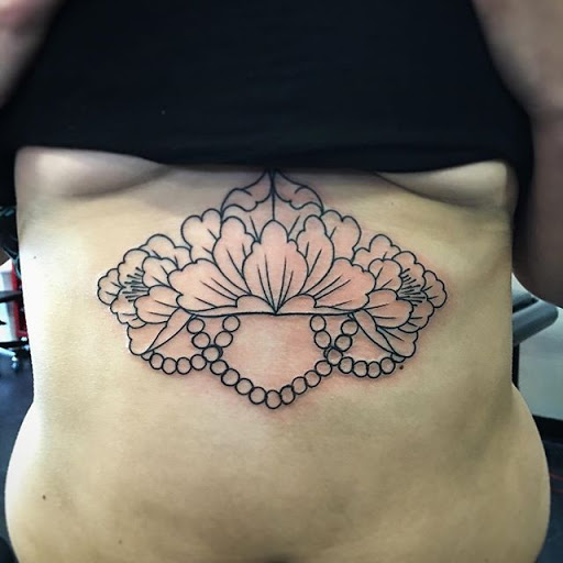 Explore rib cage tattoo ideas for guys, creative tattoo ideas in Dekalb, available at Proton Tattoo