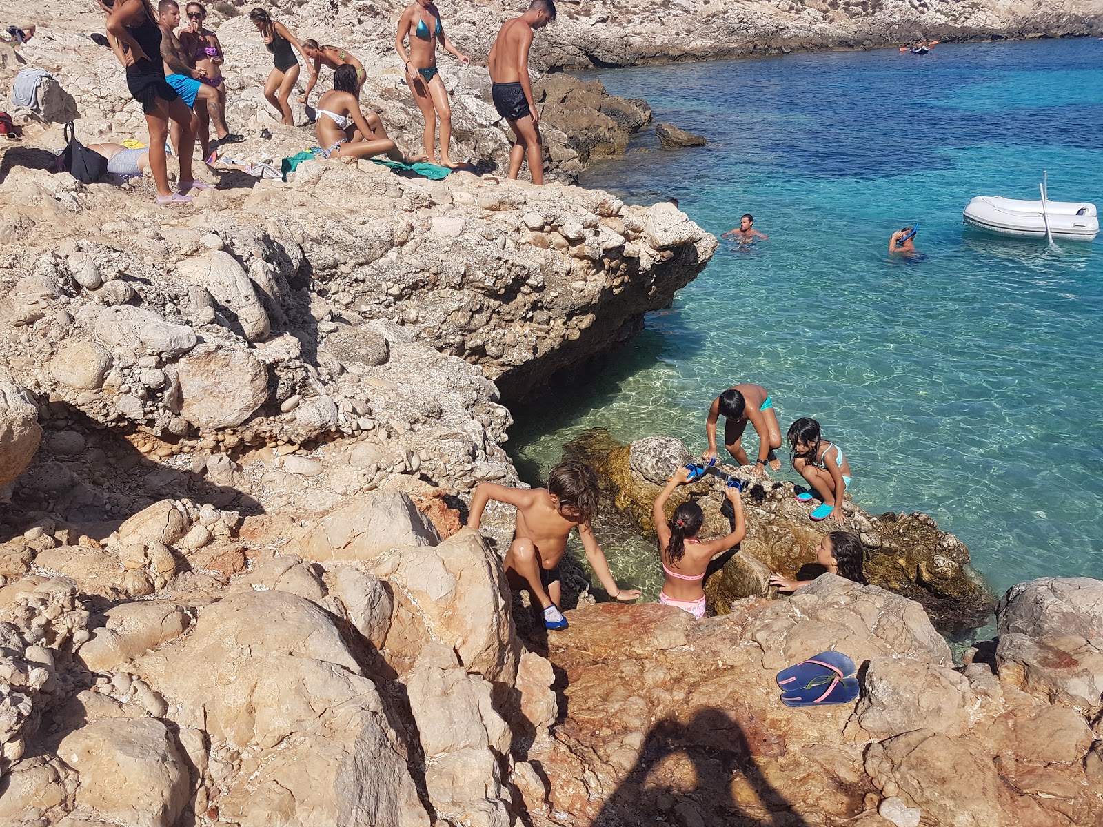Foto av Cala Minnola beach omgiven av klippor