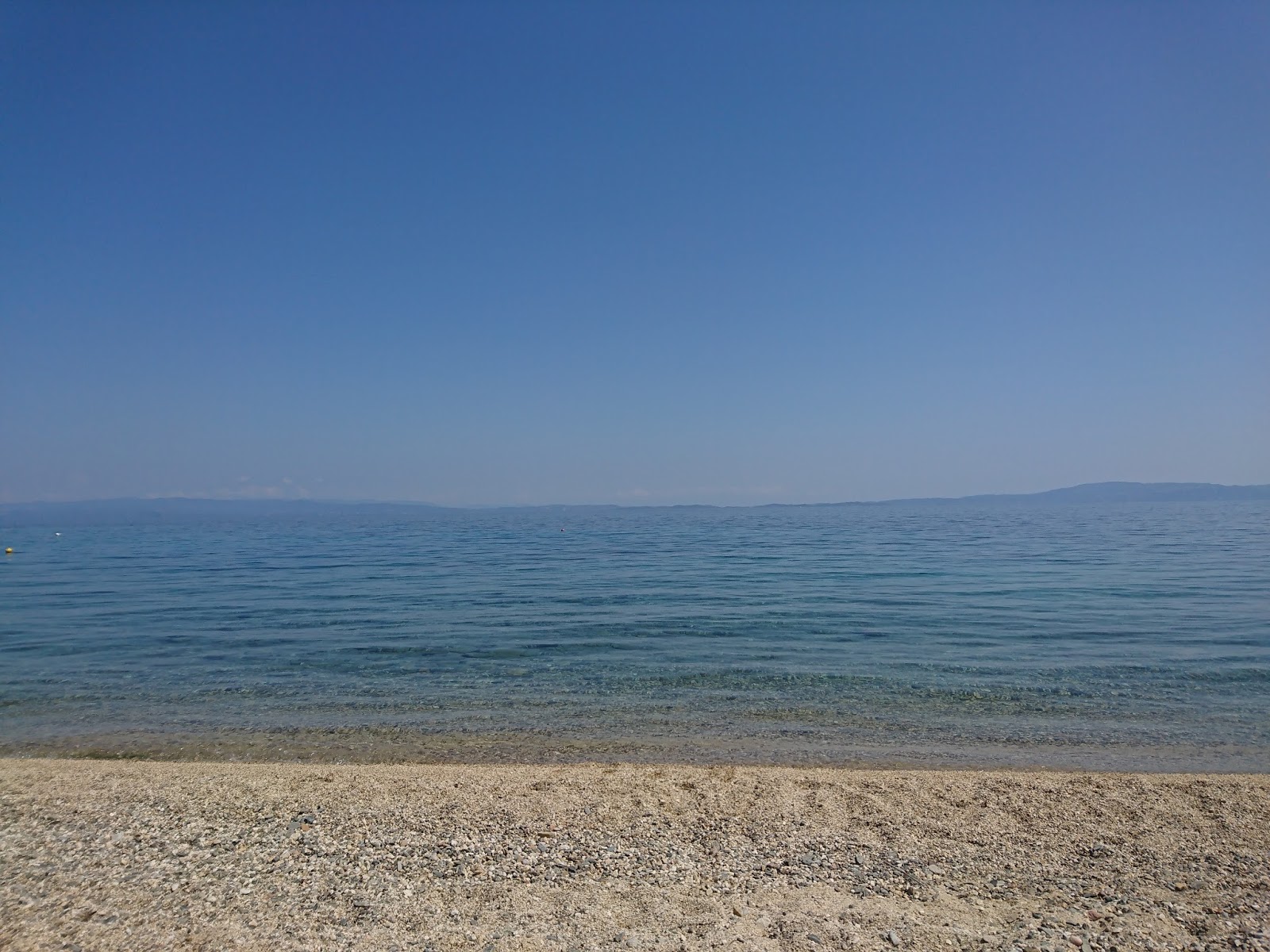 Zografou beach的照片 带有碧绿色纯水表面