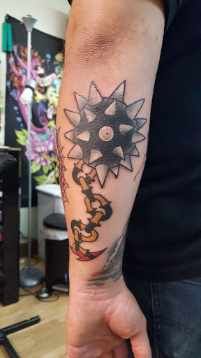 Explore boxing gloves tattoo ideas, creative tattoo ideas in Marion, available at Eternal Art Tattooing